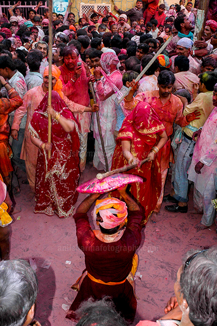 Festivals- Lathmaar Holi of Barsana (India) - A man protecting himself from womens of Barsana hitting on his shield with their sticks during Lathmaar Holi at Barsana. by Anil Sharma Photography