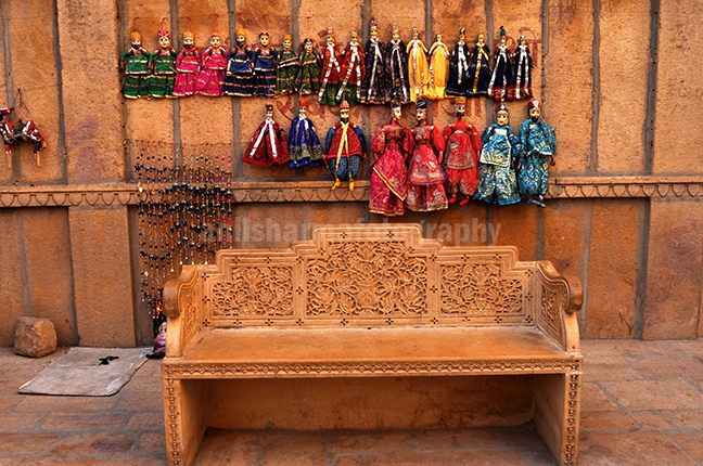 Festivals: Jaisalmer Desert Festival Rajasthan (India) - Rajasthani Puppets hanging on the wall. by Anil Sharma Photography