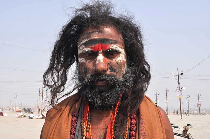 Culture- Aghori Sadhu\'s (India) - Aghori Sadhu with long hairs, ash and tilak on face wearing rudraksha bead at Mahakumbh mela, Allahabad, Uttar Pradesh, India. by Anil Sharma Photography