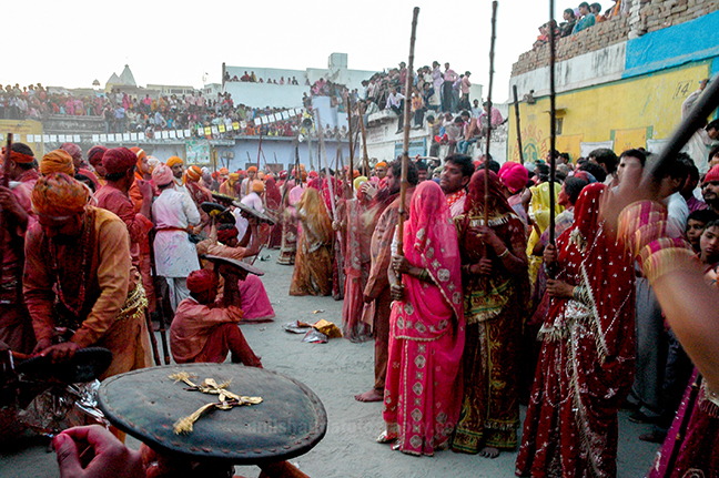 Festivals- Lathmaar Holi of Barsana (India) - women's wearing colorful saree's holding bamboo sticks during Lathmaar Holi at Barsana, Mathura, Uttar Pradesh, India. by Anil Sharma Photography
