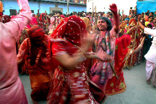 Festivals- Lathmaar Holi of Barsana (India) - Some women dancing some holding bamboo sticks, during 