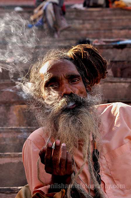 Culture- Naga Sadhu\u2019s (India) - A Naga Sadhu smoking  bidi at Varanasi ghat. by Anil Sharma Photography