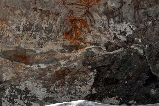 Prehistoric Rock Painting- a Hunter aiming at a deer at Bhimbetka archaeological site