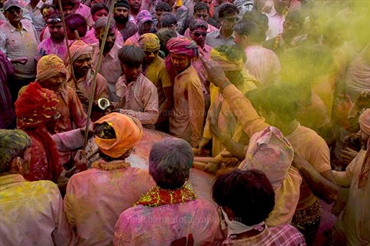 Large number of people gathered sprinkle colored powder, singing, dancing during Lathmaar Holi celebration at Barsana.