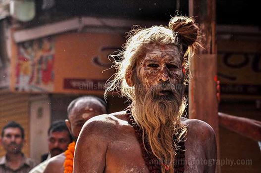An old Naga Sadhu wearing Rudraksha beads mala passing through a small lane of Varanasi.