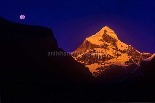 Nature-  Neelkanth Peak - Golden Neelkanth Peak with full moon in the blue sky, Garhwal, Uttarakhand, India.