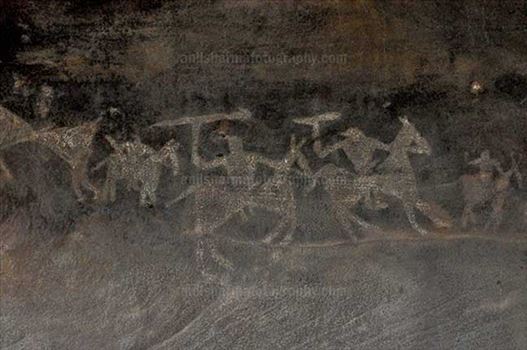 Archaeology- Bhimbetka Rock Shelters - Prehistoric Rock Painting of Worriars on horses in the battle field at Bhimbetka archaeological site