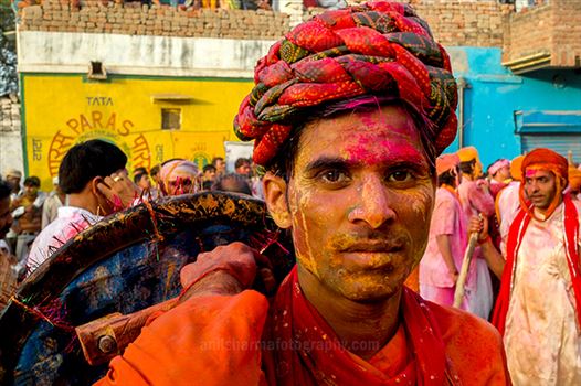 Festivals- Lathmaar Holi of Barsana (India) - A man daubed in color powder smiles as he celebrates lathmaar Holi at Barsana.