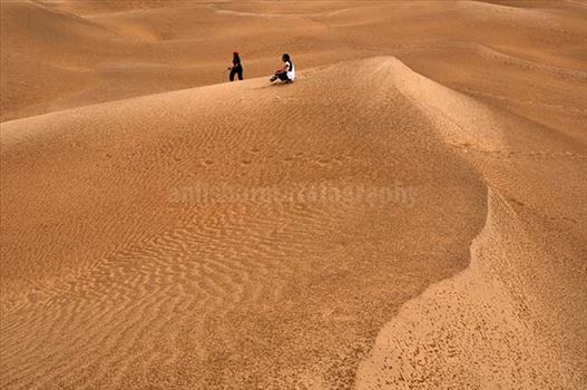 Tourists enjoying the beauty of golden sand dunes of Thar desert in Jaisalmer.