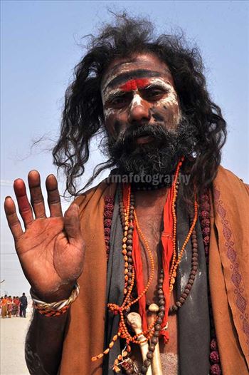 Aghori Sadhu with long hairs, ash and tilak on face wearing human bones and  rudraksha bead at Mahakumbh mela, Allahabad, Uttar Pradesh, India.